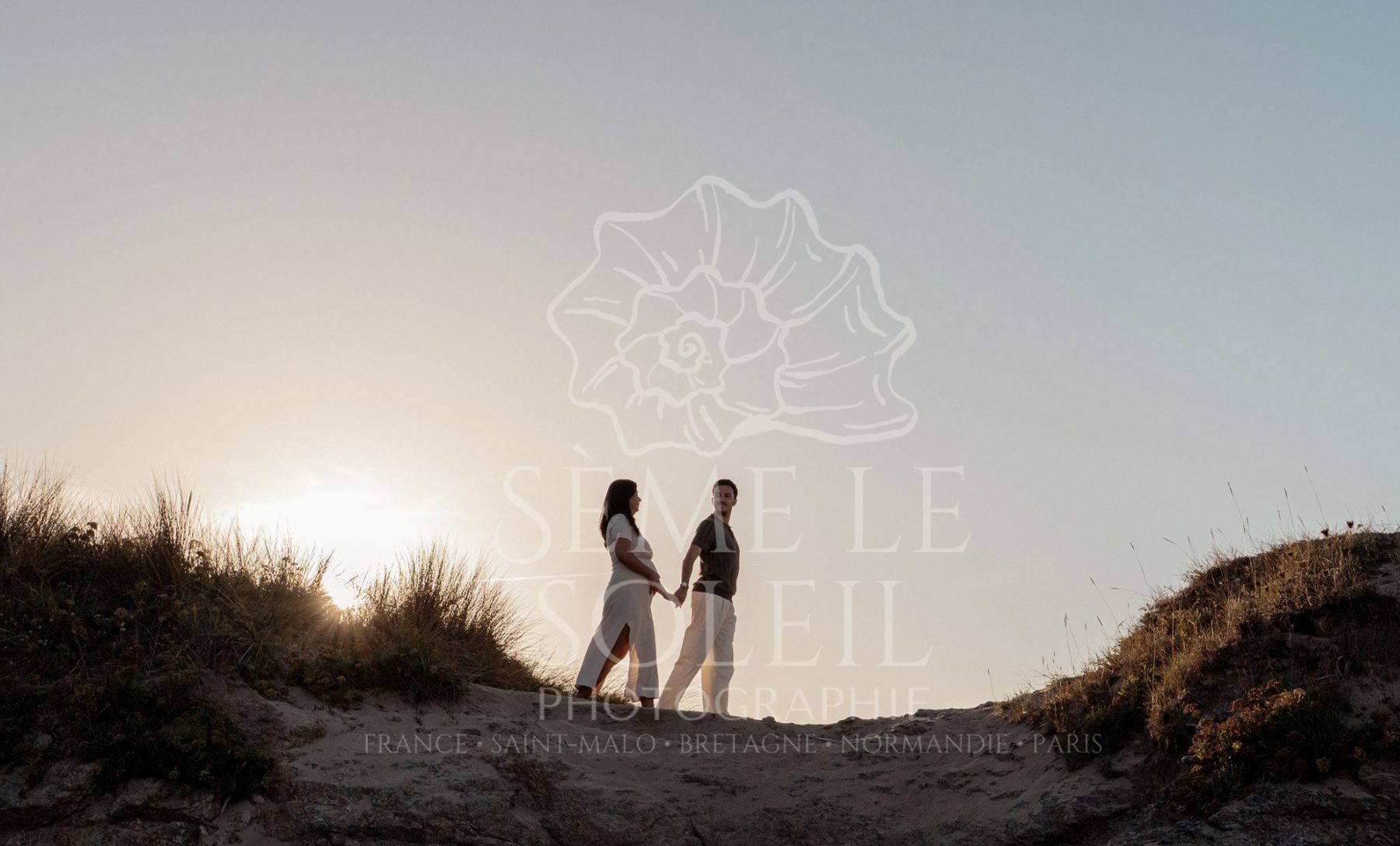 Abi et Flo main dans la main sur une dune, au coucher du soleil